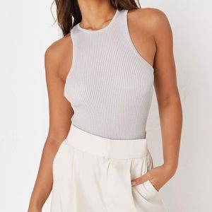 a sleeveless racer neck bodysuit